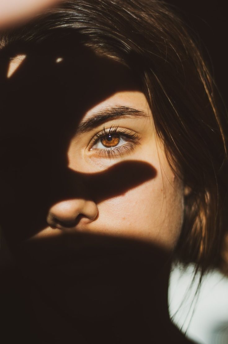 Portrait under a hand-cast shadow