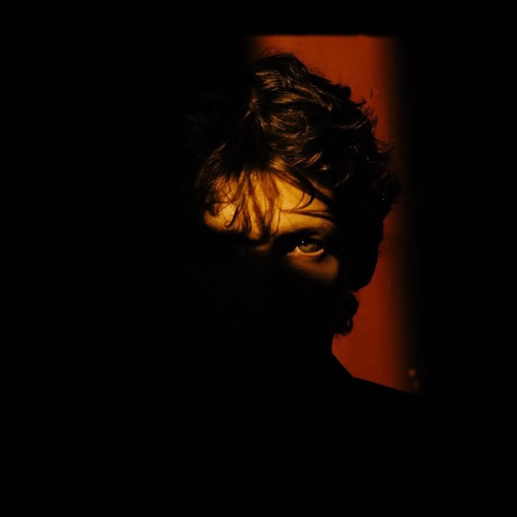 Portrait held at the edge of a red doorway